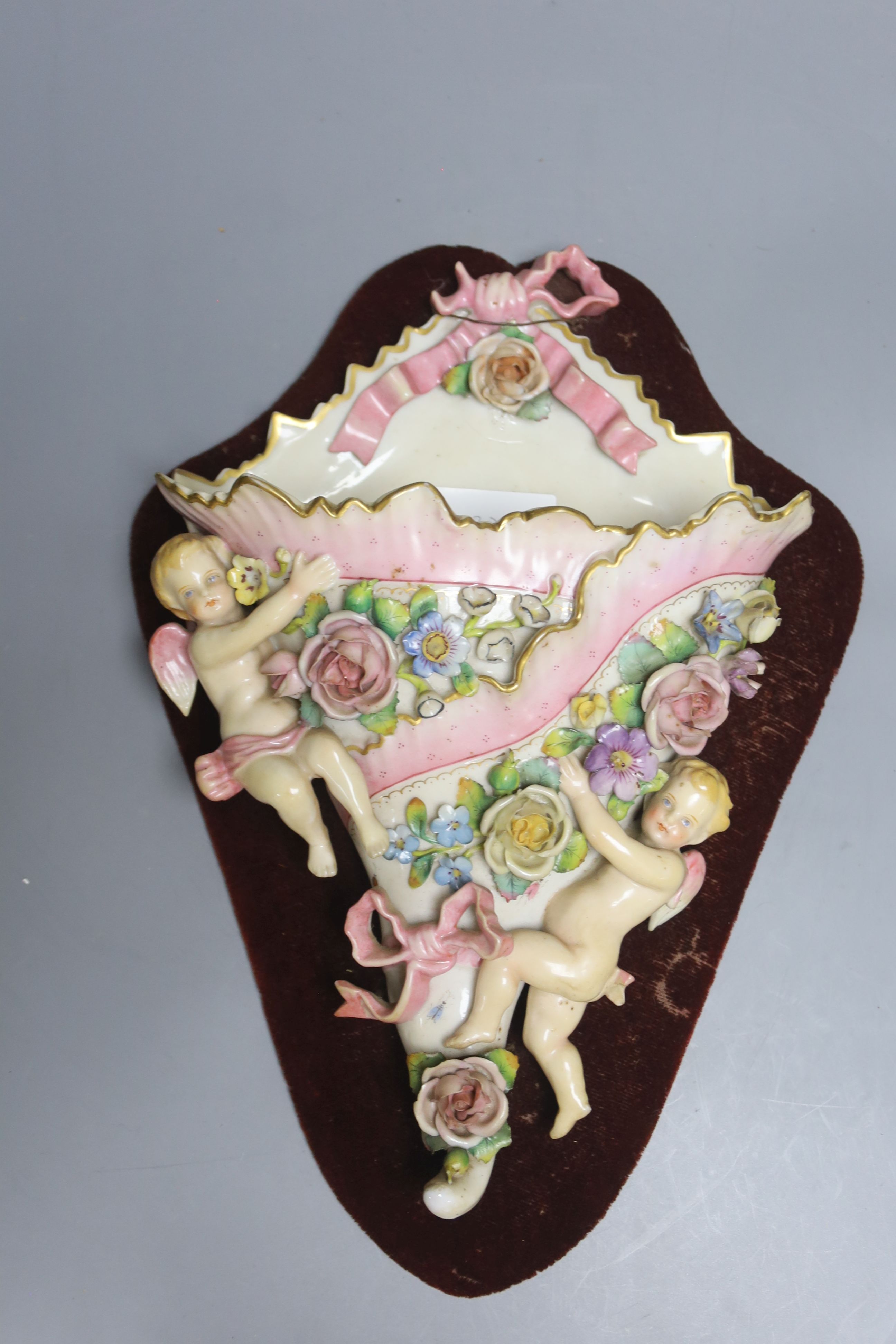 A Victorian cherub and floral porcelain wall pocket, overall 36cm